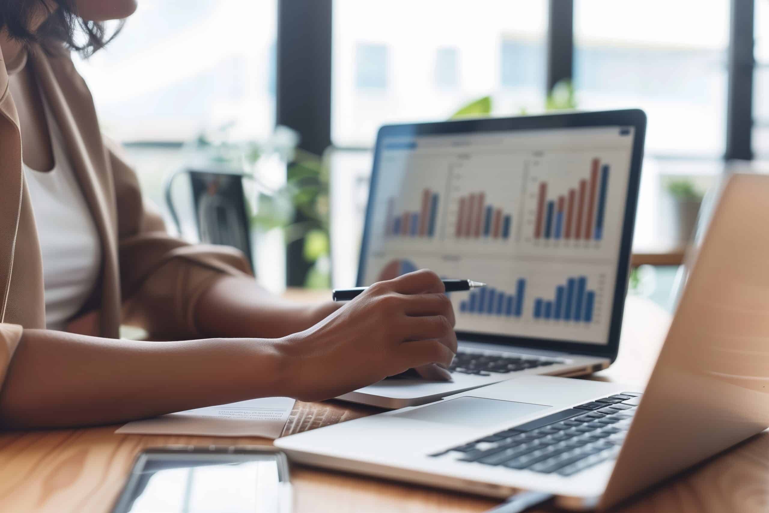 Woman on computer looking at charts related to PPC marketing strategies